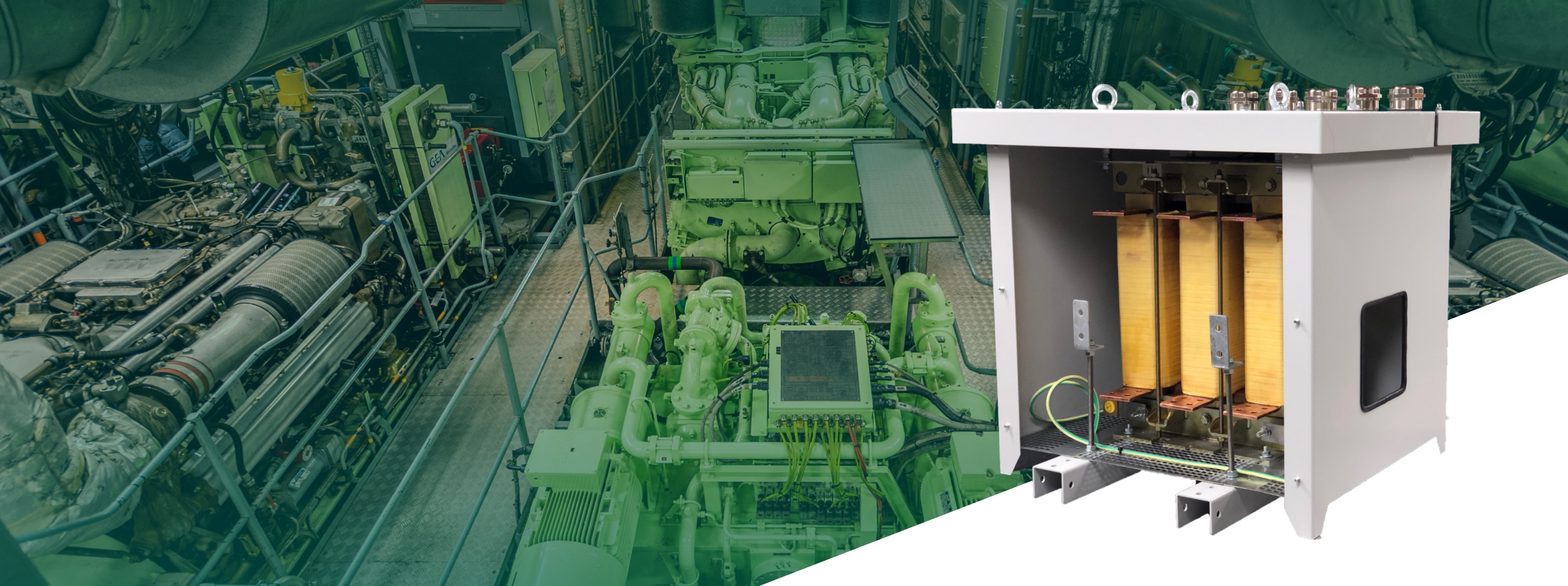 Large electrical transformer in the foreground, positioned in front of an engine room with green industrial engines and equipment